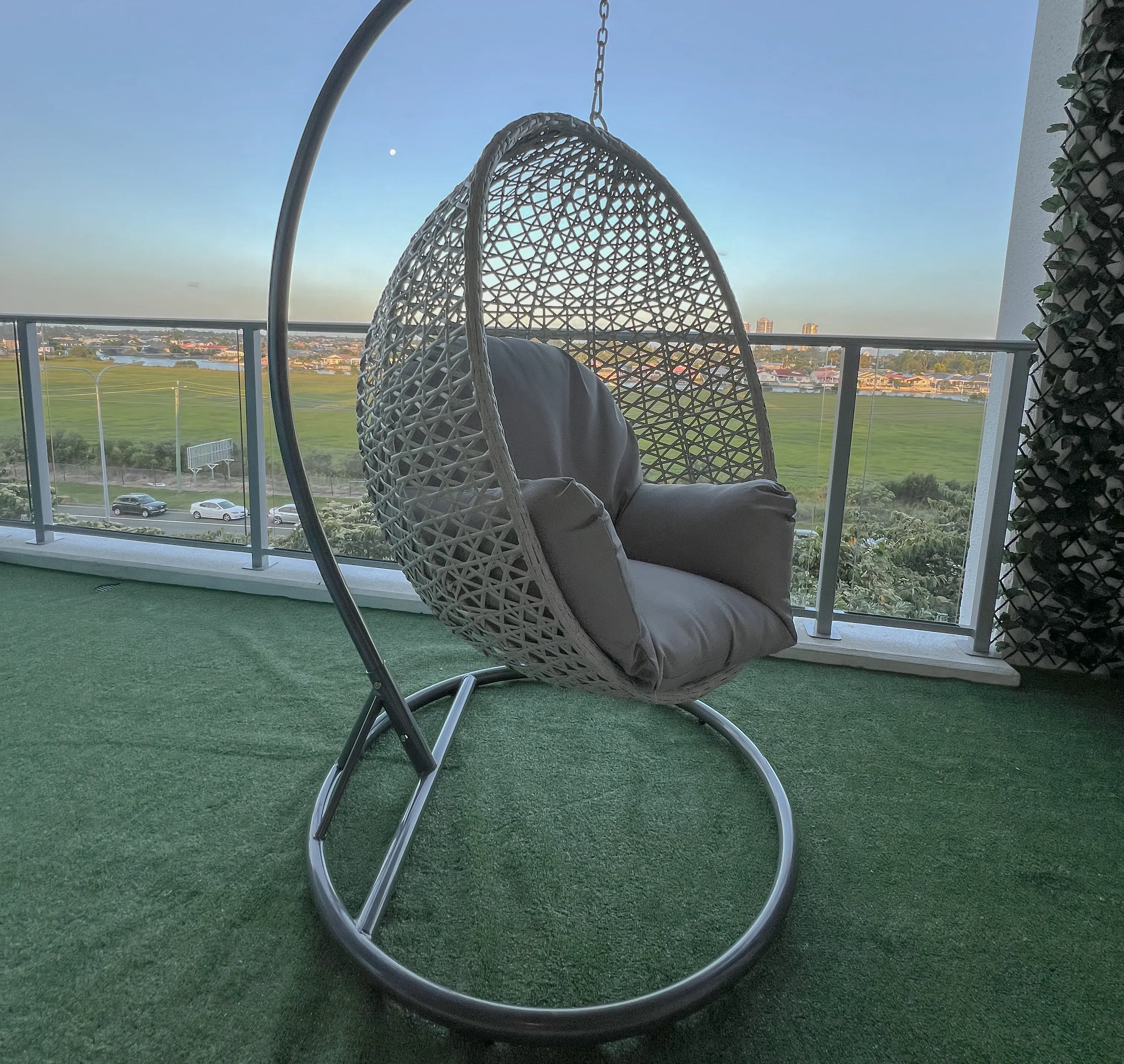 An egg-chair on the balcony as the sun sets.