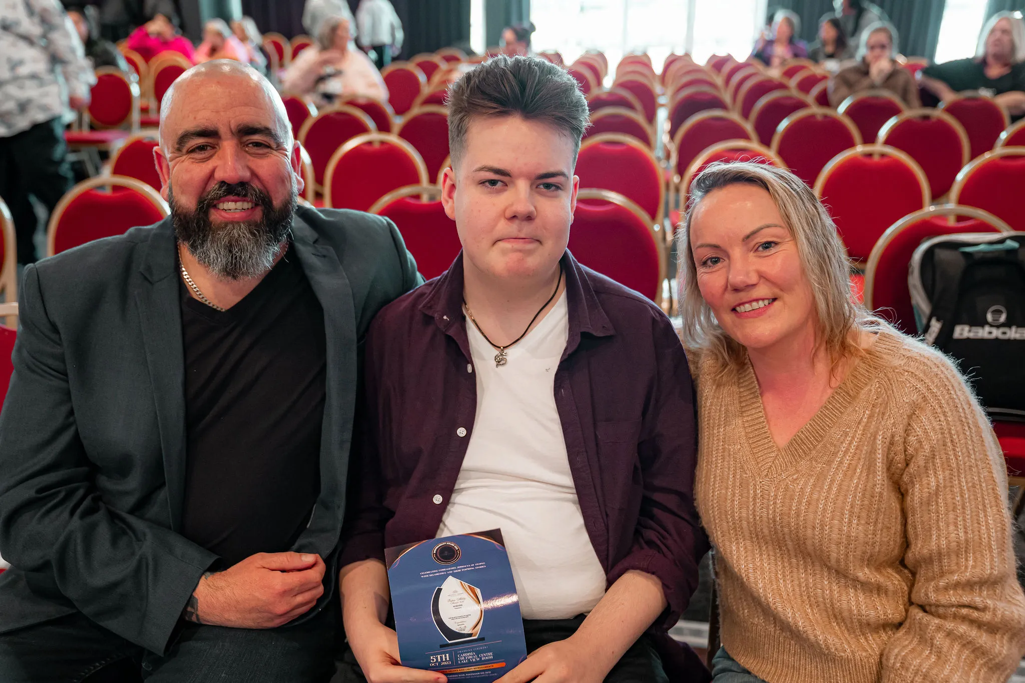 Family members posing with a Second Home award.