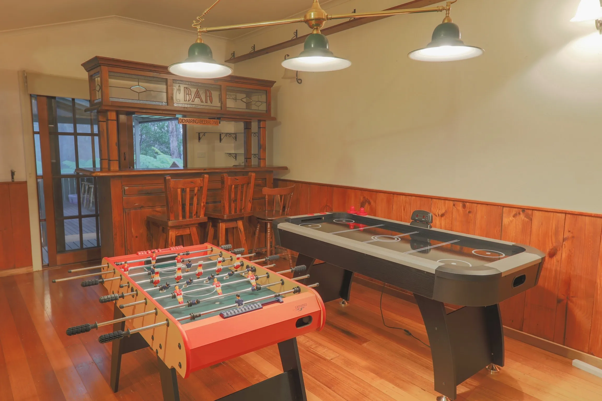 A foosball table and bar inside one of the homes.